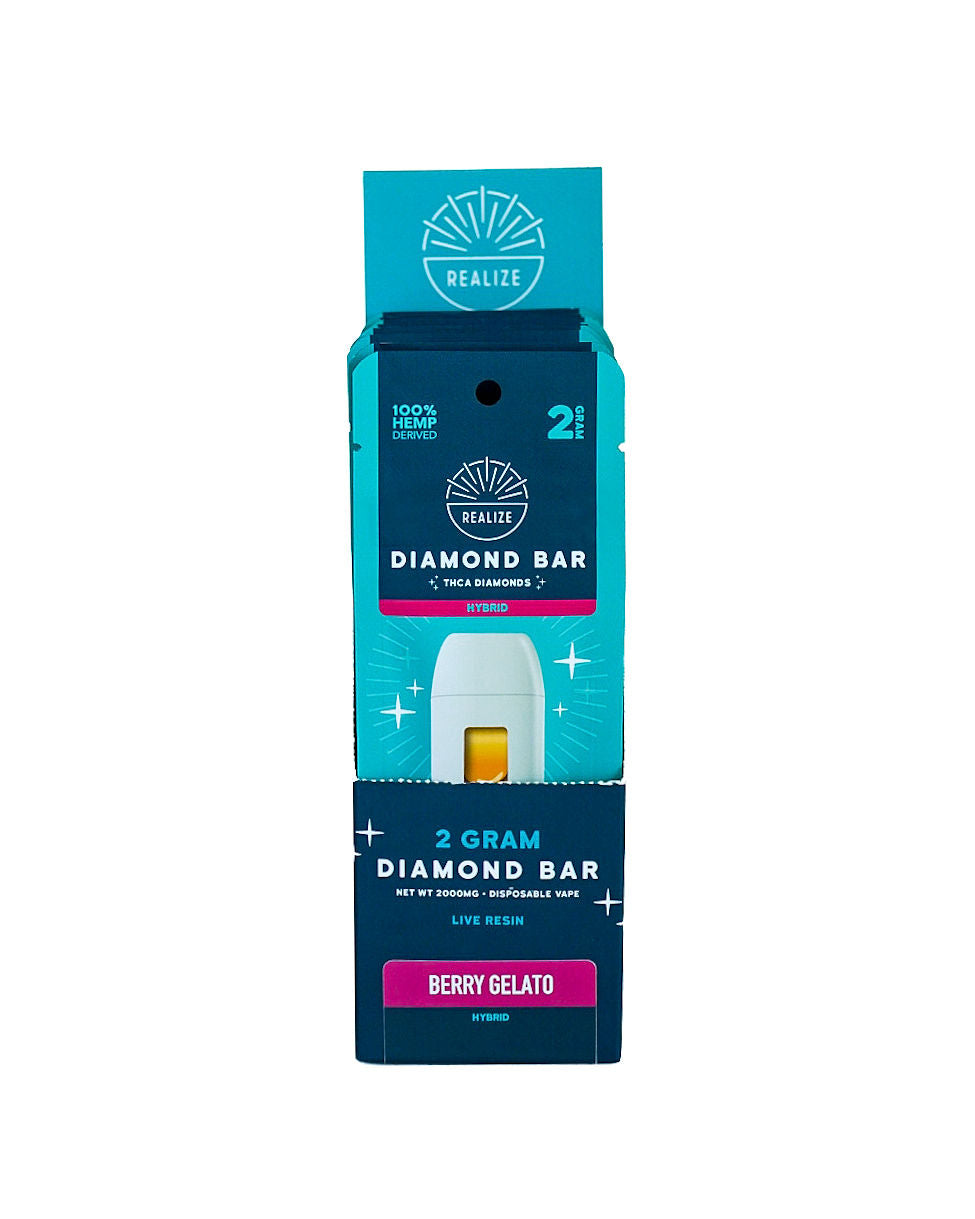 Realize Hemp Diamond Bar disposable vape packaging in Berry Gelato (Hybrid). The image shows a turquoise and navy-blue retail box partially opened to reveal a white vape device with visible amber oil. Packaging features the Realize logo and product details including "2 Gram Diamond Bar," "THCa Diamonds," "Live Resin," and "100% Hemp Derived." The Berry Gelato strain is displayed on a magenta label, with Hybrid designation shown on the packaging. Product photographed against a light gray background.